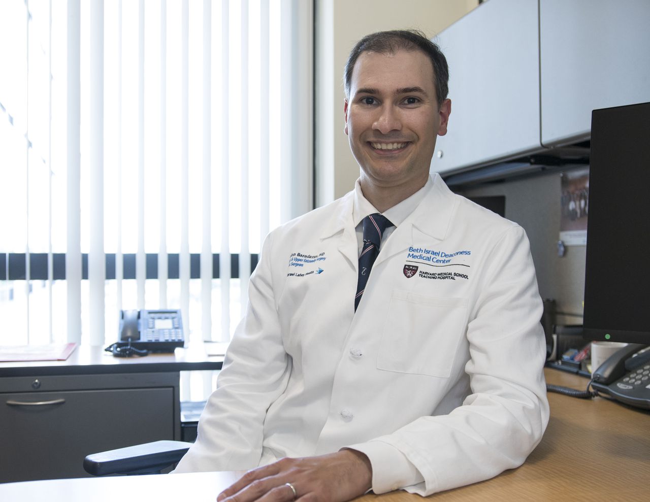 Dr. Baradaran in a white coat at the hospital
