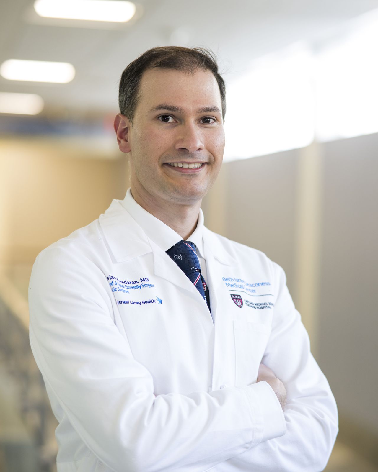 Dr. Baradaran in a white coat at the hospital